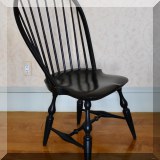 F24. 7 Black painted Windsor chairs. 